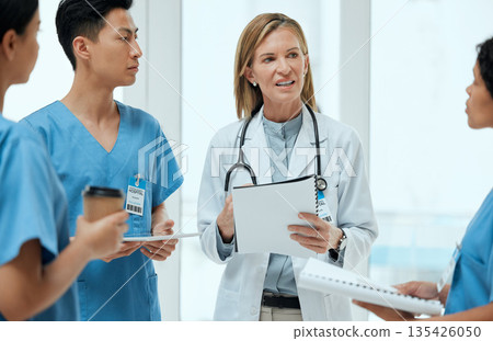 Teamwork, discussion or doctors with a report in meeting planning a surgery strategy in collaboration. Leadership, woman or surgeons talking or speaking of healthcare paperwork, documents or research Teamwork, discussion or doctors with a report in meeting planning a surgery strategy in collaboration. Leadership, woman or surgeons talking or speaking of healthcare paperwork, documents or research 135426050