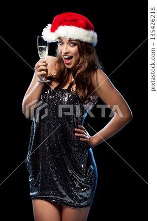 Christmas, portrait and excited woman with champagne in studio isolated on a black background. Xmas hat, celebration and happy person with wine glass, alcohol or drink for holiday, party and sparkle Christmas, portrait and excited woman with champagne in studio isolated on a black background. Xmas hat, celebration and happy person with wine glass, alcohol or drink for holiday, party and sparkle 135426218