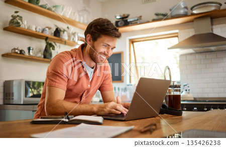 Smile, laptop and remote work, happy man at kitchen counter with app for email, social media or networking for online job. Technology, communication and freelancer on internet writing blog or article 135426238
