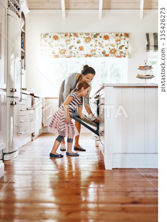 Food, mother with her child baking and in the kitchen of their home with a lens flare. Happy family or bonding time, bake or cook and woman with girl at the oven prepare a meal for lunch together 135426273