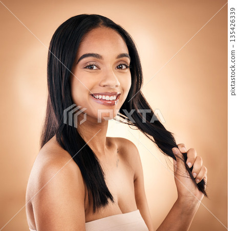 Portrait, hair and shampoo with a model woman in studio on a brown background for keratin treatment. Face, salon and smile with a happy young person looking confident about haircare cosmetics 135426339