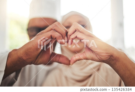 Love, Muslim or senior couple with heart hands for support, trust and care in retirement, bonding or marriage. Emoji icon, Islamic home or Arab man, woman and elderly people together for quality time 135426384
