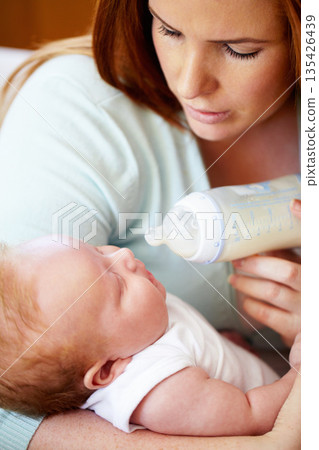 Mom, milk and feed baby from bottle for nutrition, healthy breakfast and diet in the morning. Mother, child and feeding newborn formula food for growth, development and wellness together in home. Mom, milk and feed baby from bottle for nutrition, healthy breakfast and diet in the morning. Mother, child and feeding newborn formula food for growth, development and wellness together in home. 135426439