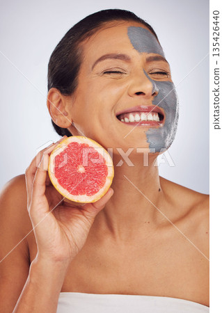 Woman, skincare, with grapefruit and face mask with charcoal, clay or natural beauty product for wellness, detox or nutrition. Fruit, healthy cosmetics and girl happy with vitamin c or facial care Woman, skincare, with grapefruit and face mask with charcoal, clay or natural beauty product for wellness, detox or nutrition. Fruit, healthy cosmetics and girl happy with vitamin c or facial care 135426440