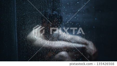 Man, dark shower and sad by glass in home, stress and mental health with ptsd for bad memory. Person with depression, burnout and anxiety with water drops, window and frustrated in bathroom at house Man, dark shower and sad by glass in home, stress and mental health with ptsd for bad memory. Person with depression, burnout and anxiety with water drops, window and frustrated in bathroom at house 135426508