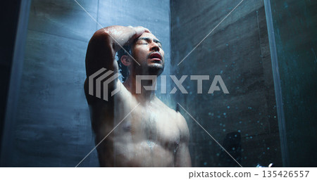 Water, stress and man in bathroom with shower for mental health, grief or anxiety with body care. Person with depression, exhausted and low angle for upset, disappointment or morning routine in home Water, stress and man in bathroom with shower for mental health, grief or anxiety with body care. Person with depression, exhausted and low angle for upset, disappointment or morning routine in home 135426557