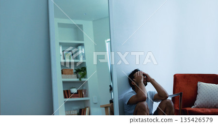 Stress, frustrated man and overwhelmed in house, poor mental health or anxiety for financial crisis. Bankruptcy, depressed or burnout person with debt worry, emotional breakdown or space for pressure 135426579