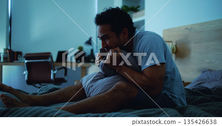Night, pillow and stressed man with anxiety, mental health and sleepless from sad memories in bed. Late, contemplation and anxious person with depression, grief and insomnia from frustration in home. Night, pillow and stressed man with anxiety, mental health and sleepless from sad memories in bed. Late, contemplation and anxious person with depression, grief and insomnia from frustration in home. 135426638
