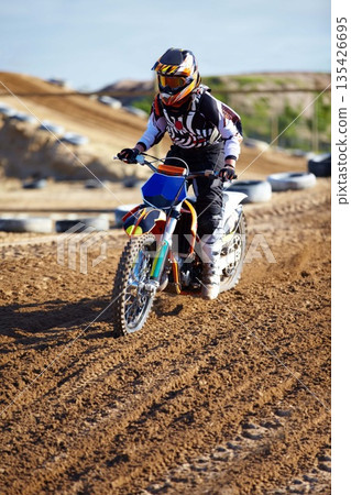 Adventure, offroad and biker riding a motorcycle with speed for a race or sport competition. Sports, fitness and male athlete on motorbike for adrenaline, training or practicing on outdoor dirt trail 135426695