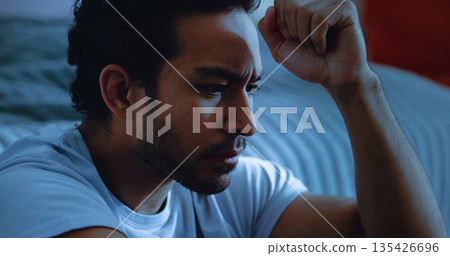 Night, worry and man thinking with anxiety, mental health or insomnia from sad memories in bedroom. Late, contemplation or anxious person with depression, grief or sleepless from stress in apartment. 135426696