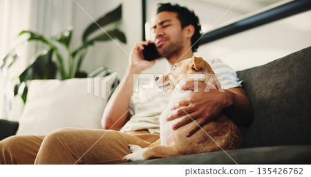 Home, phone call and man on couch, dog and relax with communication in living room. Apartment, pet owner and person on sofa, smartphone and talking to contact, animal care or digital app for chatting Home, phone call and man on couch, dog and relax with communication in living room. Apartment, pet owner and person on sofa, smartphone and talking to contact, animal care or digital app for chatting 135426762