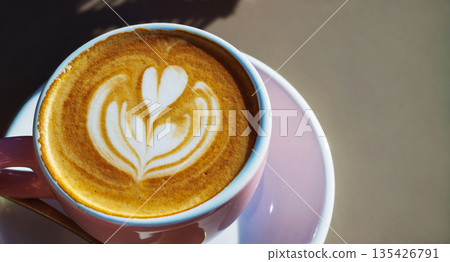 Cup of latte with heart latte art on saucer in natural day light with copy space 135426791