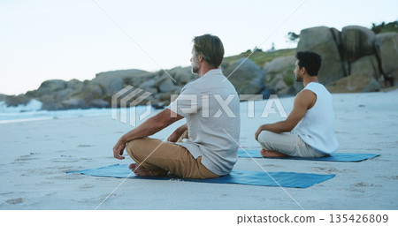 Zen, people and yoga at beach with meditation, reflection and peaceful moment for spiritual awareness. Calm, men and wellness at ocean with mindfulness, chakra alignment or relax for holistic health. 135426809