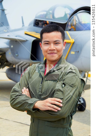Portrait of man, pilot in military with jet and confident smile at airforce base with arms crossed in Korea. Freedom, transport and proud Asian soldier with airplane, confident and service in army. 135426811