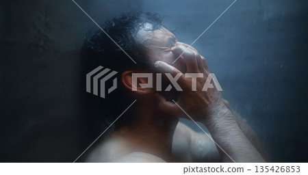 Mental health, angry and man in shower with reflection, anxiety trigger or memory of past trauma. Grief, flashback and male person in bathroom with sadness, regret or fatigue in emotional thoughts. Mental health, angry and man in shower with reflection, anxiety trigger or memory of past trauma. Grief, flashback and male person in bathroom with sadness, regret or fatigue in emotional thoughts. 135426853