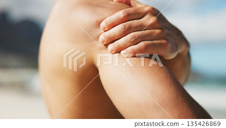 Hand, shoulder and pain at beach with tension, inflammation or stiff joint with fibromyalgia. Person, topless with pressure or spasm of muscle ache, injury or body burnout with cramps outdoor Hand, shoulder and pain at beach with tension, inflammation or stiff joint with fibromyalgia. Person, topless with pressure or spasm of muscle ache, injury or body burnout with cramps outdoor 135426869