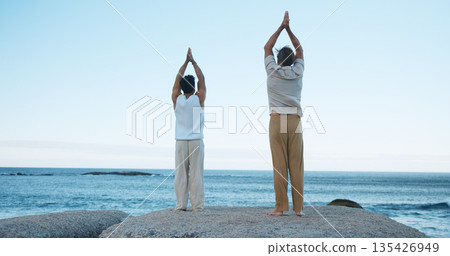Men, back view or meditation with beach for spiritual healing or wellness on ocean coast. Male people, yoga or reiki with tai chi or exercise for channeling body energy, flexibility or peace on space Men, back view or meditation with beach for spiritual healing or wellness on ocean coast. Male people, yoga or reiki with tai chi or exercise for channeling body energy, flexibility or peace on space 135426949