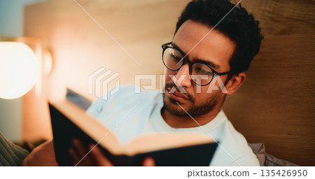 Reading book, evening and man in bed, glasses and comfortable with entertainment. Night, eyewear and person with novel, house and hobby with cozy activity, literature and fiction story with poetry Reading book, evening and man in bed, glasses and comfortable with entertainment. Night, eyewear and person with novel, house and hobby with cozy activity, literature and fiction story with poetry 135426950