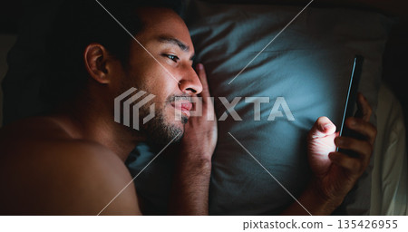 Night, man and lay in bed with phone for text message reply, social media and check dating site. Late, person and scroll with technology in apartment for online conversation, internet and mobile app. Night, man and lay in bed with phone for text message reply, social media and check dating site. Late, person and scroll with technology in apartment for online conversation, internet and mobile app. 135426955