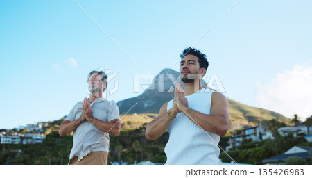 Men, prayer and meditation for mindfulness, beach and routine for peace, low angle and stress relief. Outdoor, space and people with spiritual awareness in nature, namaste and faith for wellness 135426983