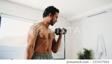 Home, fitness and man with dumbbell for workout, strength development or muscle gain for body goals. Challenge, strong or active bodybuilder with arm exercise, low angle or weightlifting for training Home, fitness and man with dumbbell for workout, strength development or muscle gain for body goals. Challenge, strong or active bodybuilder with arm exercise, low angle or weightlifting for training 135427003