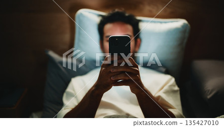 Night, man and hands in home with phone for text message reply, social media post or watching video. Late, person and typing with tech in bed for online conversation, browsing internet or mobile app. Night, man and hands in home with phone for text message reply, social media post or watching video. Late, person and typing with tech in bed for online conversation, browsing internet or mobile app. 135427010