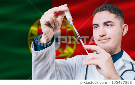 Doctor holding syringe on Portugal flag background. Medical professional holding syringe with Portuguese flag in the background 135427898