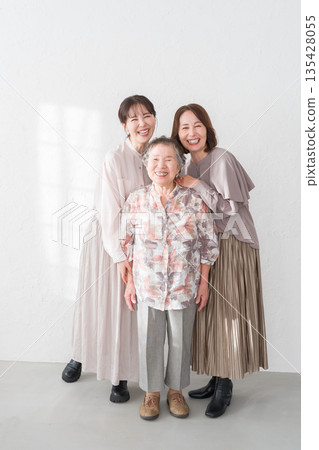 Smiling female three generation family Smiling female three generation family 135428055