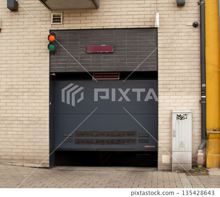 Unusual garage entrance with traffic light in an urban setting near  135428643