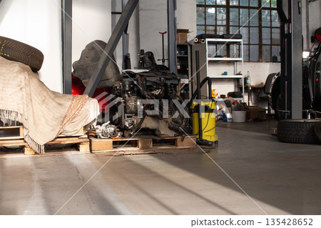 Engine on wooden pallets in an industrial garage during daylight Engine on wooden pallets in an industrial garage during daylight 135428652