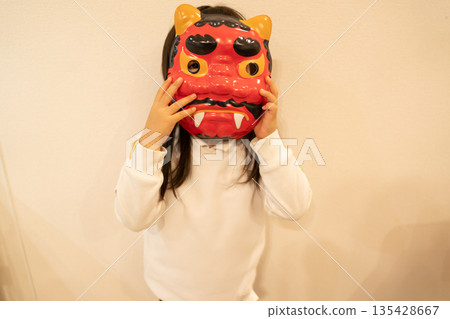 A girl wearing a red demon mask for Setsubun 135428667