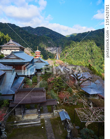 Autumn scenery of Nachisan Seiganto-ji Temple's three-story pagoda and Nachi Falls in Nachikatsuura, a tourist attraction in Wakayama Prefecture 135428701
