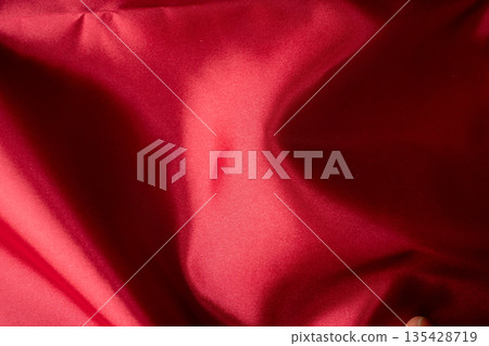 Background material depicting the folds and texture of red fabric Background material depicting the folds and texture of red fabric 135428719