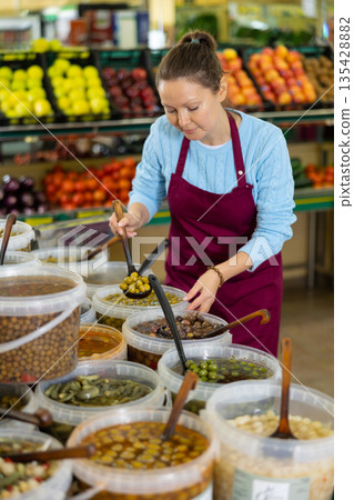 woman seller offers to buy olives 135428882