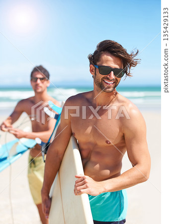 Beach, travel and man surfing friends outdoor together for summer vacation or holiday trip overseas. Surf, sea or fun with a shirtless young male surfer in sunglasses and friend bonding on the coast Beach, travel and man surfing friends outdoor together for summer vacation or holiday trip overseas. Surf, sea or fun with a shirtless young male surfer in sunglasses and friend bonding on the coast 135429133