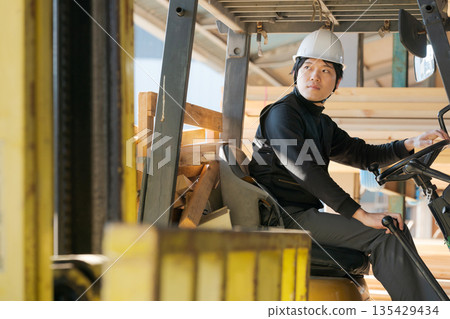Man operating a forklift Man operating a forklift 135429434