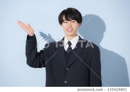 A high school boy's upper body pose looking at the camera against a light blue background. Recommended pose for introducing yourself and your career path. A high school boy's upper body pose looking at the camera against a light blue background. Recommended pose for introducing yourself and your career path. 135429801