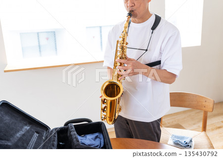 Senior man playing the saxophone 135430792