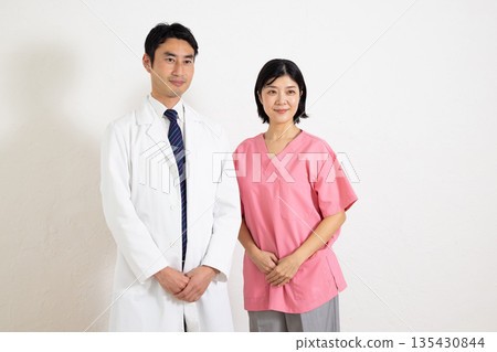 A male doctor and a female nurse smiling with a confident expression 135430844