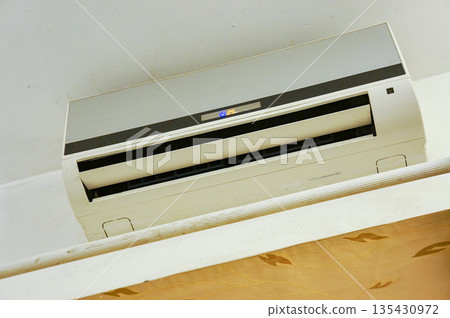 The air conditioner installed in the room is an old model and has become less effective. The air conditioner installed in the room is an old model and has become less effective. 135430972