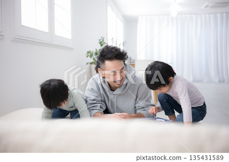 Parents and children study together using tablets and learn while playing on holidays. Father and son (brothers) enjoy parenting. Parents and children study together using tablets and learn while playing on holidays. Father and son (brothers) enjoy parenting. 135431589