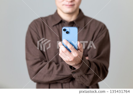 Male man who operates a smartphone 135431764
