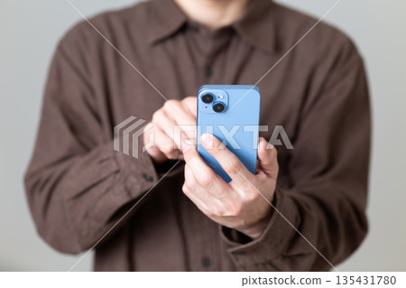 Male man who operates a smartphone Male man who operates a smartphone 135431780