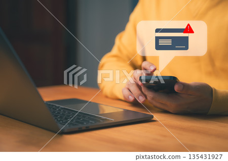 Credit card alert notification concept showing person holding smartphone with warning message, symbolizing online payment error, digital banking security risk, and financial fraud prevention. Credit card alert notification concept showing person holding smartphone with warning message, symbolizing online payment error, digital banking security risk, and financial fraud prevention. 135431927
