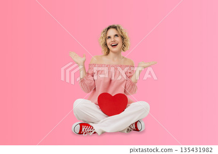 Valentine's Day scene with a woman holding a red heart 135431982