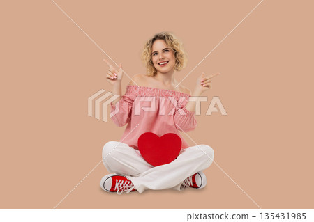 Valentine's Day: a model smiles with a heart 135431985