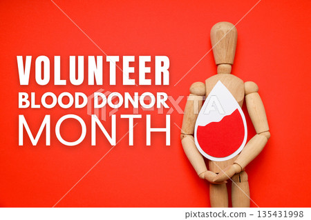 Wooden figure holding a blood drop symbol on a red background 135431998