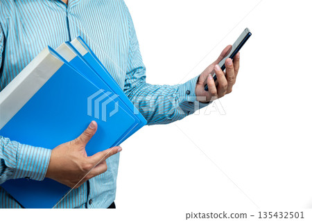 Close-up of Asian businessman holding blue folders in one hand and using smartphone with the other, representing multitasking, office work, document management, and digital communication efficiency Close-up of Asian businessman holding blue folders in one hand and using smartphone with the other, representing multitasking, office work, document management, and digital communication efficiency 135432501