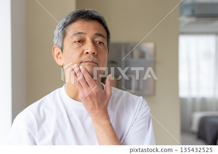 Senior man suffering from skin trouble Senior man suffering from skin trouble 135432525