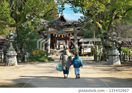 Parent and child visiting a shrine 135432667